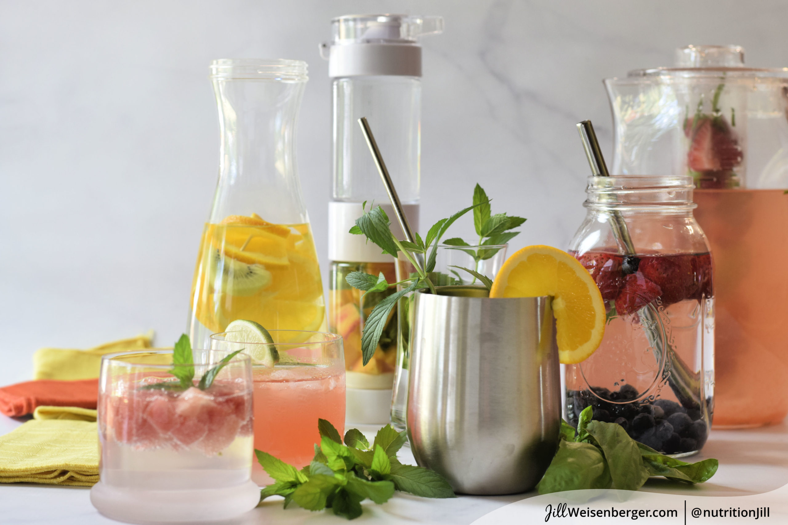 Glasses and pitchers with water, fruit and herbs to flavor water naturally