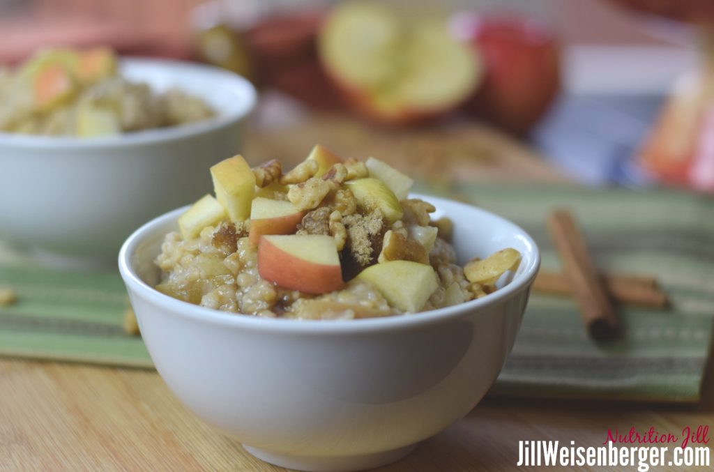 healthy spices like cinnamon and cardamom in oats and lentils with apples in a white bowl