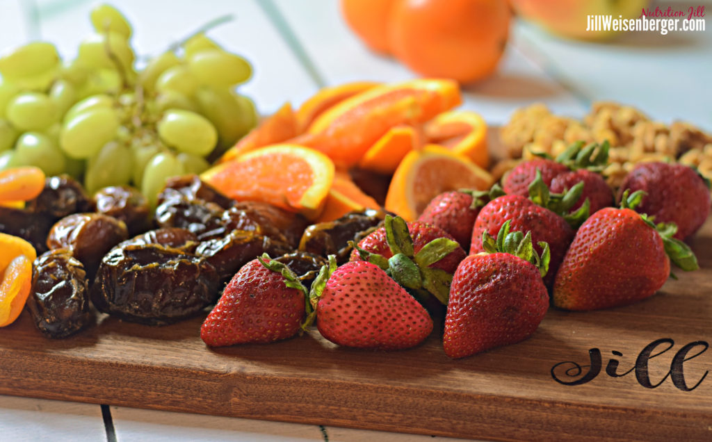 Fresh and dried fruit on a board for snacking