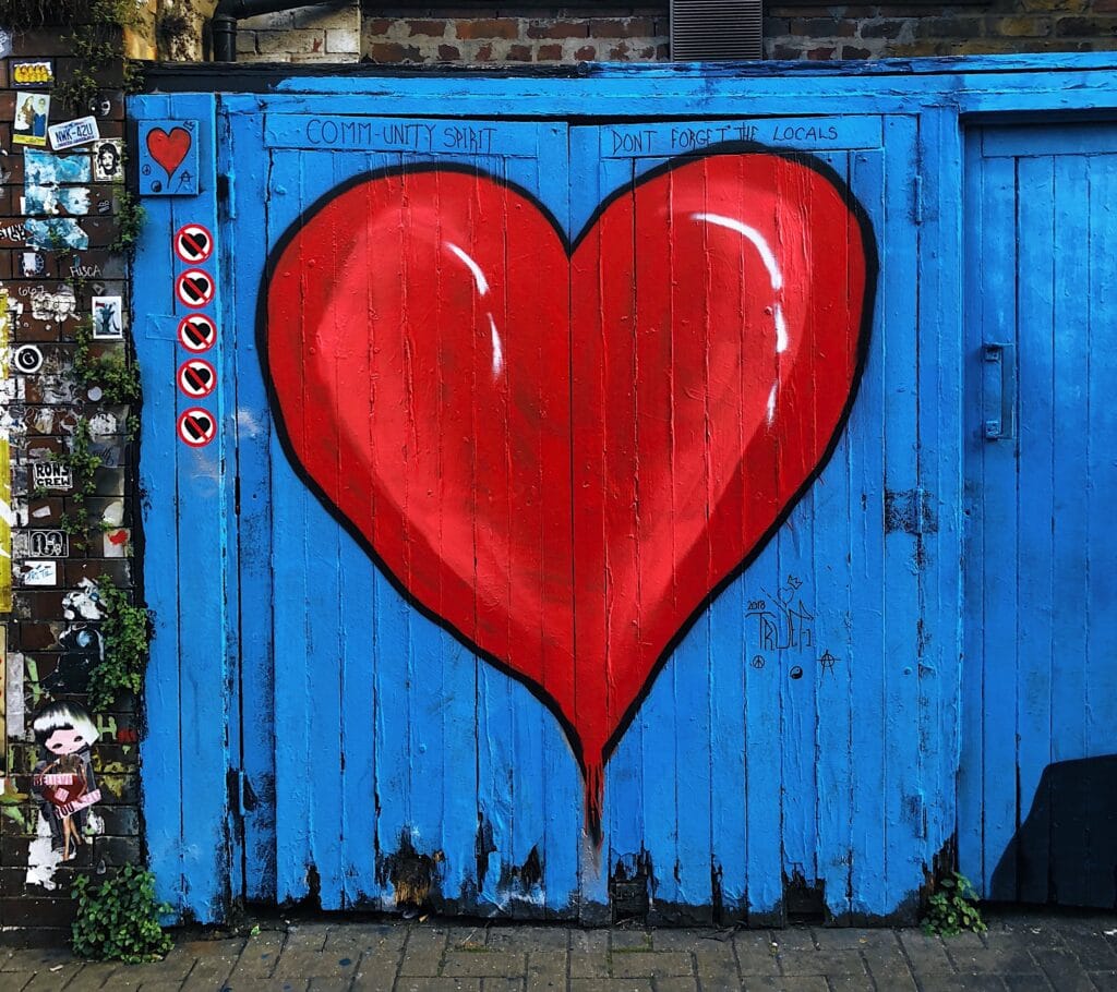 blue wooden gate with painted red heart