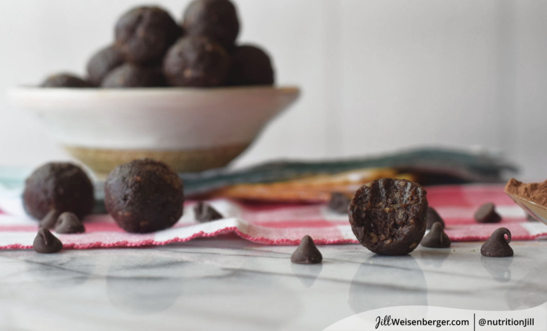 healthy chocolate walnut date balls in a bowl with chocolate chips
