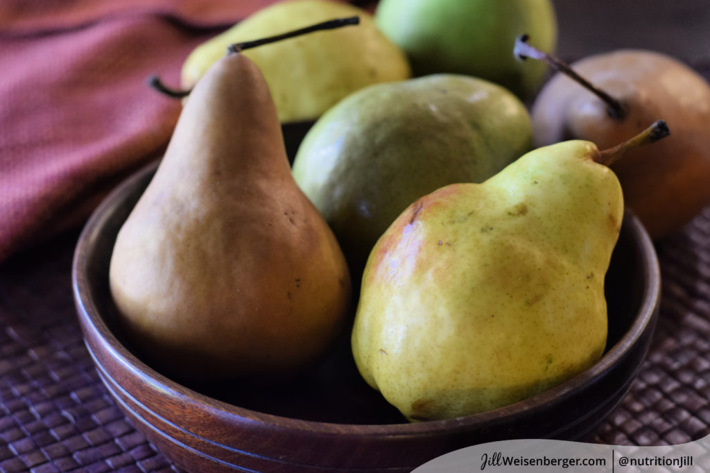 a bowl of colorful fresh pears as part of a brain healthy diet