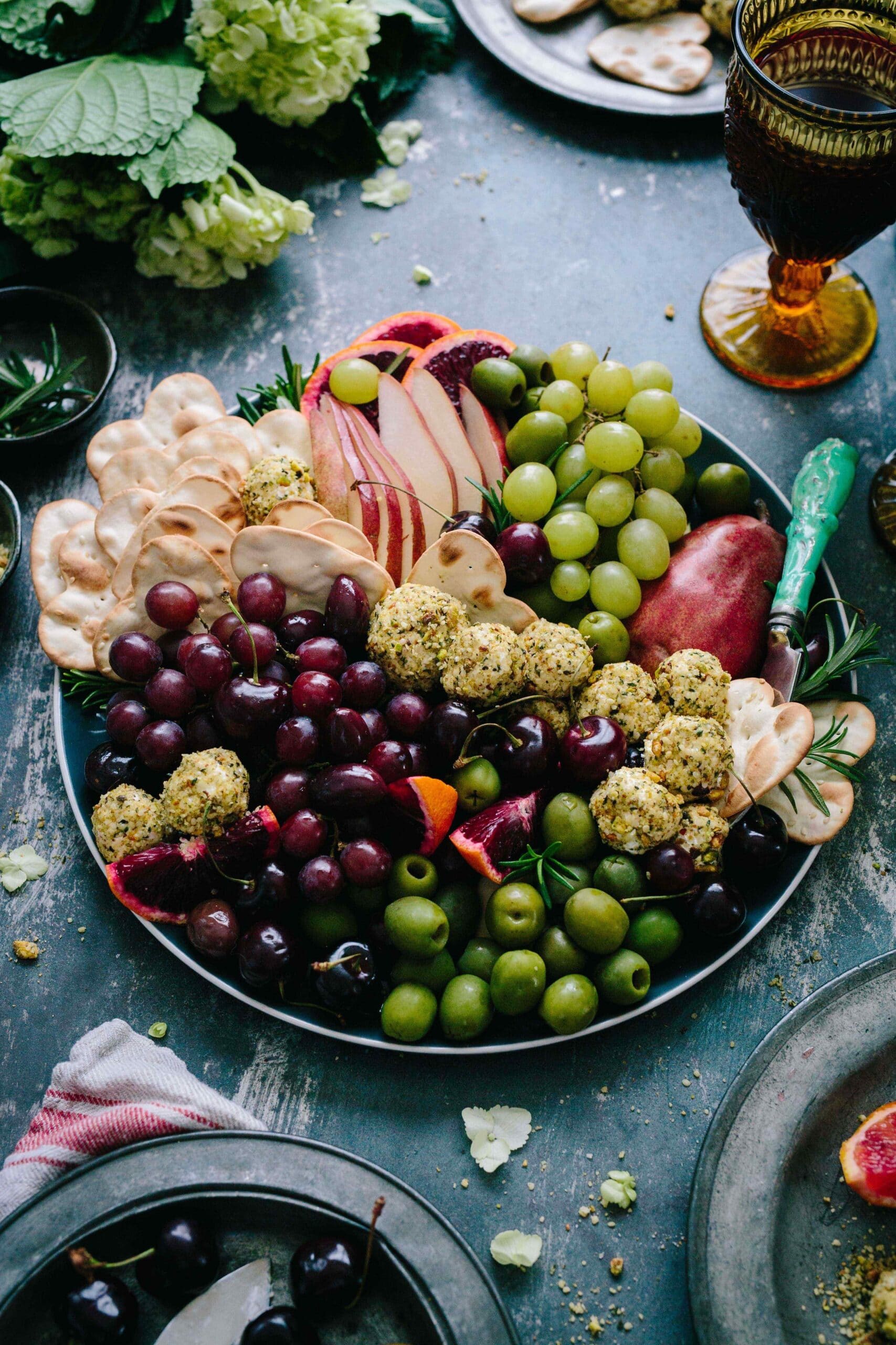 Olives, fruit and crackers on a silver tray